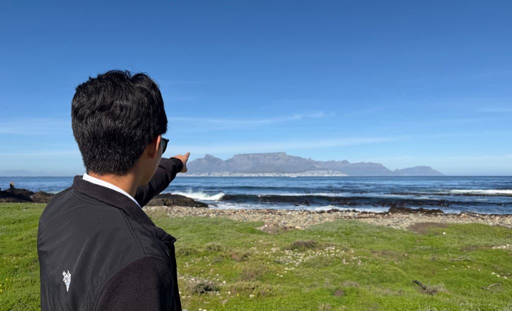 Pointing across the water toward Table Mountain from Robben Island