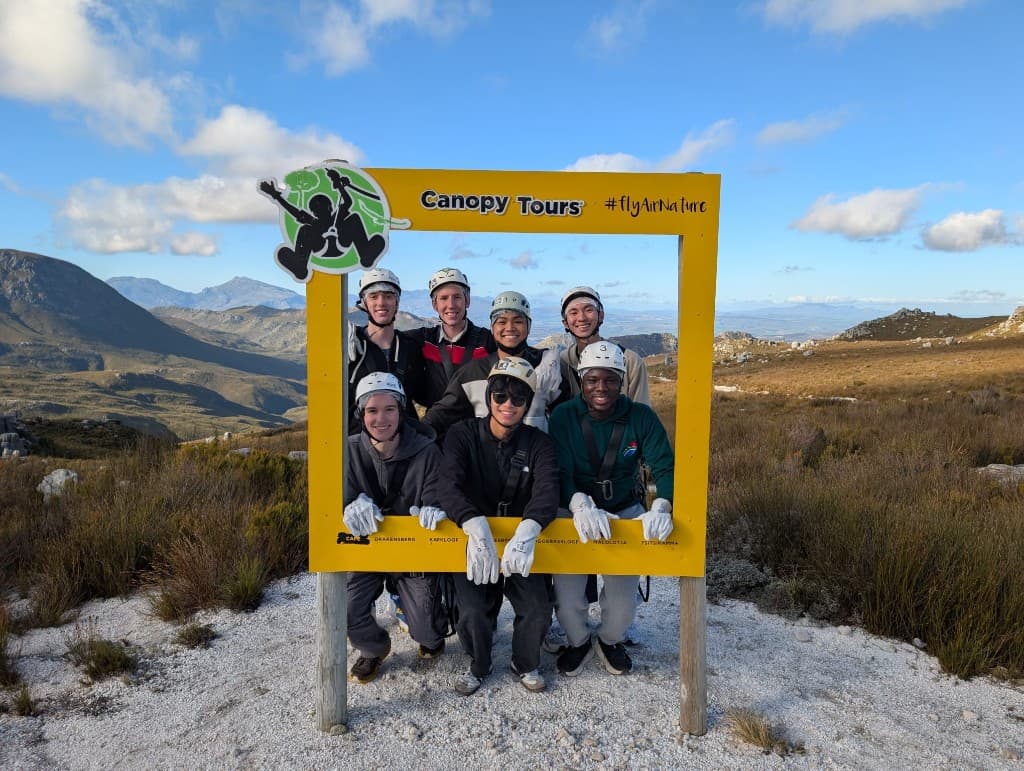 The cohort in helmets and harnesses before zip-lining